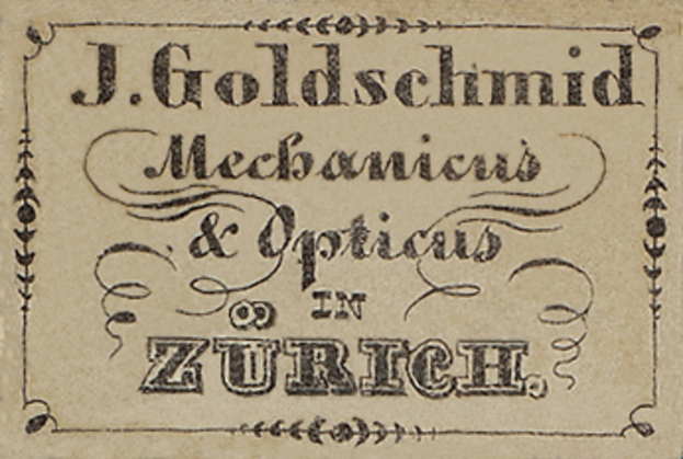 Eine alte Visitenkarte mit der Aufschrift "J. Goldschmidt Mechanicus & Optics in Zürich", wahrscheinlich aus dem frühen 20. Jahrhundert.