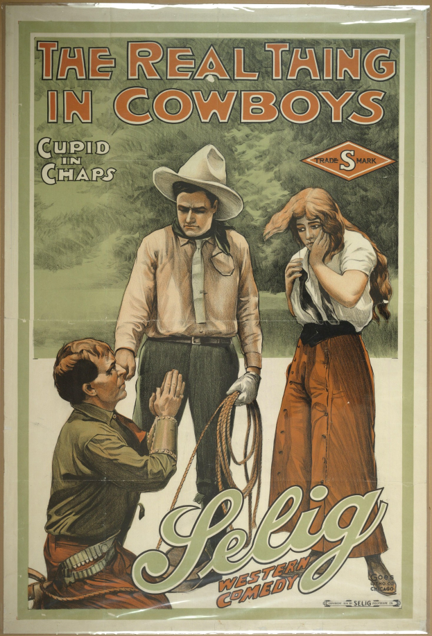 Plakat mit der Aufschrift "The Real Thing in Cowboys" mit zwei Männern in Cowboyhüten und einer Frau in einem langen Kleid vor einem hellgelben Hintergrund.