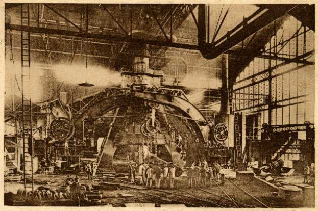Ein Schwarz-Weiß-Foto einer Fabrikszene bei Cadillac Steel Works, das Menschen bei der Bedienung einer großen Maschine zeigt, umgeben von Leitern, Stangen und anderen Geräten.