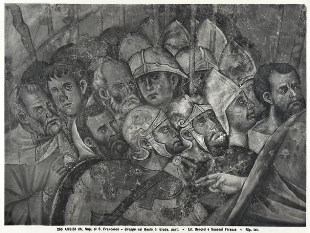 Eine Schwarz-Weiß-Zeichnung einer Gruppe verzweifelter Männer in einer Menge, einige schauen ängstlich nach oben, andere verwirrt nach unten, mit Text, der eine Schlachtenszene anzeigt.